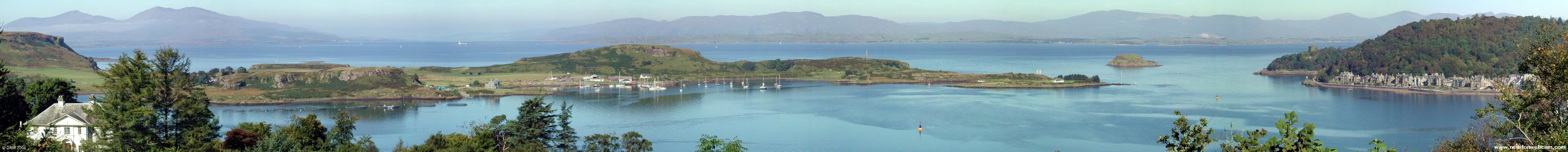 Panoramic view from Pulpit Hill, Oban
This panoramic view was taken from the Pulpit Hill viewpoint above Oban.  Kerrera Island stretches across the bay in front of Oban with the Firth of Lorn behind.  The lighthouse on Lady's Rock marks the entrance to Loch Linnhe with Lismore Island to its right.  On the right hand side is the north end of Oban with the ruins of Oban Castle.
