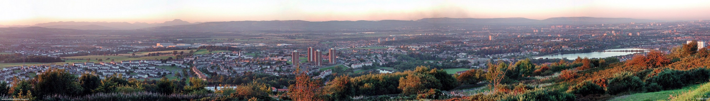 Gleniffer Braes evening sun panorama
The tower blocks of the Glasgow in the distance on the right are illuminated by the setting sun.  Taken in 2004 before the Foxbar flats were demolished.  The Distinctive outline of Ben Lomond can be left of centre.  [url=http://www.multimap.com/map/browse.cgi?lat=55.8143&lon=-4.4656&scale=25000&icon=x/]Map location[/url]
