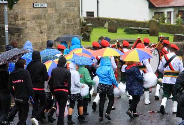 2008, Neilston Live Parade
If nothing else, the rain during the 2008 parade did at least produce a colour display of Umbrellas.


