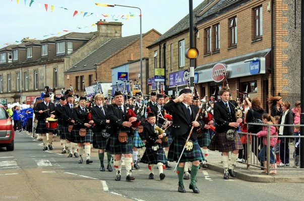 2008, Taking the Salute
Pipe Major Ian MacDonald takes the salute as he leads the Neilston & District Pipe band, followed by the parade, through the village to the show ground.

