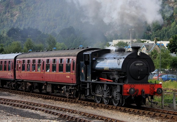 A Hunslet 0-6-0ST Steam Engine pulls out from Aviemore
The Hunslet 'Austerity' was a war time locomotive designed for the war department as the standard shunting engine.  Some 480 were built between 1943 and 1964.  This particular example is spending its retirement at Strathspey Preservation Railway in the summer of 2008. 
