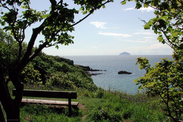 The perfect seat for a perfect day
Looking out over the firth of Clyde From Culzean Country Park towards the Island of Ailsa Craig.  You can just see Turnberry Lighthouse to the left.  Look closely and you see the area around the seat is covered in Bluebells
