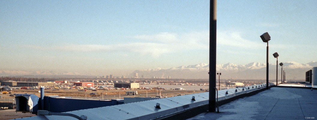 Anchorage, Alaksa, 1985
A distant view of the centre of Anchorage from the viewing area at the Airport.  You might just be able to make out small planes of every shape and size at the edge of the aiport.
