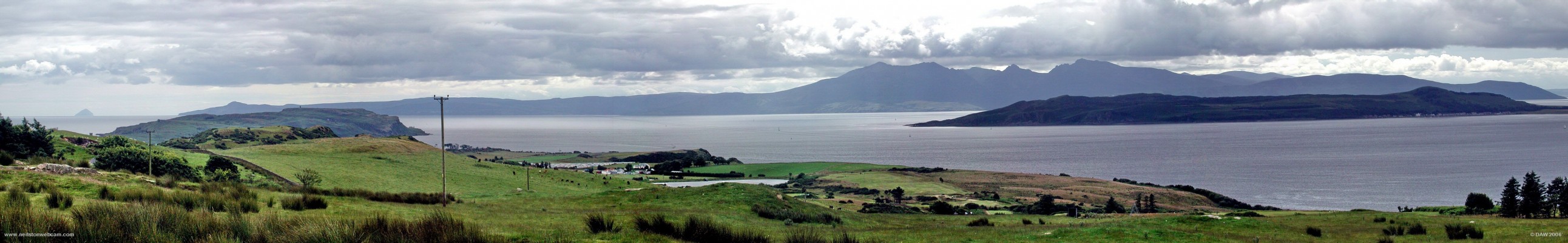 A view of Arran from the Glaid stone, Great Cumbrae
The Island of Ailsa Craig can be seen on the horizon on the left,  Arran stretches from the right of that all across the photo.  The Wee Cumbrae is a slightly different shade of green, if you look close you can even spot the Castle on the left hand side and the lighthouse (disused) on the right hand side.  On the right is the tail end of Bute with the houses of Kilchattan Bay clearly visible. [url=http://www.multimap.com/map/browse.cgi?lat=55.7725&lon=-4.9229&scale=25000&icon=x/]Map location[/url]
