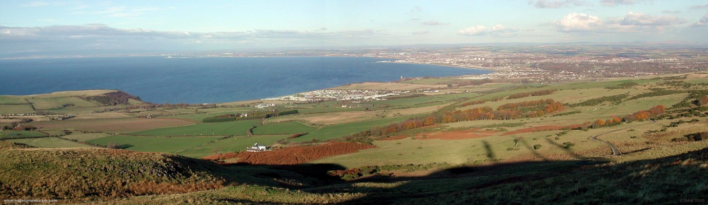 Over looking Ayr Bay from Carrick Brown Hill
Carrick Brown hill rises to 279m and gives this spectacular view over the town of Ayr on the right and all the way up the Ayrhire coast to Troon, Irvine and beyond.  The Heads of Ayr are on th left,  the shadows of the 3 communications masts on top of the hill can be seen on the hillside. [url=http://www.multimap.com/map/browse.cgi?lat=55.4099&lon=-4.7023&scale=25000&icon=x/]Map Location.[/url] 
