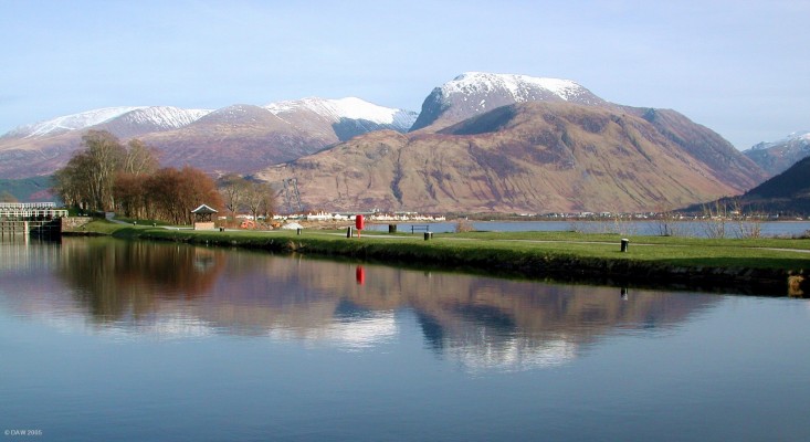 Ben Nevis, viewed from Corpach
A vew of Ben Nevis as seen from Corpach. Ben Nevis is the highest mountain in the British Isles, rising to a height of 1344 metres.  The Caledonian Canal is in the foreground with Loch Linnhe just visible behind.  The town of Fort William is lies at the foot of the mountains along the loch shore.
