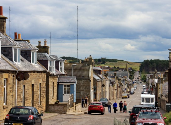 Burghead, Moray
Looking down Grant Street in the coastal village of Burghead.  The aerial masts in the background date from 1936 and broadcast BBC Radio 4 Long Wave, one of only three sites in the UK to do so. [url=http://streetmap.co.uk/map.srf?X=310977&Y=869077&A=Y&Z=110/] Map location. [/url]
