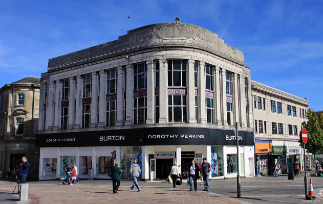 Burtons, Paisley Cross
This catagory B Art Deco style building was built in 1930 on a vacant corner site in Paisley Cross.  Previous to this building the entrance to the Glen Cinema was on the corner leading to the Cinema behind. On the 31st December 1929 71 Children died in a fire in the cinema.  The cinema building was converted into the shops you see to the right of Burtons. [url=http://www.streetmap.co.uk/map.srf?X=248336&Y=664027&A=Y&Z=115/] Map location. [/url]
