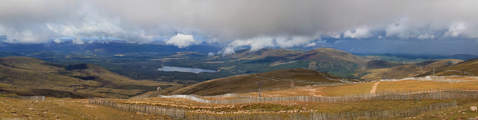 A view from the Ptarmigan Cafe on Cairngorm
Left of centre is Loch Morlich surrounded by The Queens Forest.  Above the Loch and to the left  is the town of Aviemore.  As can be seen from the ski tows and lifts scattered about the hill side this area of Cairngorm is popular with Skiers in winter.  But the season only lasts a few months even on a good year.  [url=http://www.streetmap.co.uk/map.srf?X=293447&Y=809527&A=Y&Z=126&ax=300447&ay=804927/] Map location. [/url]

