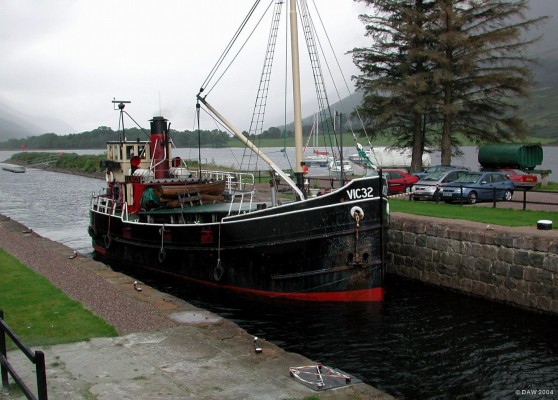 Vic 32 at the Caledonian Canal, Loch Lochy
Vic 32 entering the locks at the Laggan end of Loch Lochy.  Vic 32, built in 1943, is a former Clyde puffer and now used for cruises around the canals and west coast.  In Aug 2004 it failed its boiler certification and its future was in doubt, however, in 2005 the Heritage lottery fund awarded ?100,000 which will not only replace the boiler but allow other repairs to be done to the hull.  Vic 32 should again be sailing the waters of the west coast in 2006.

