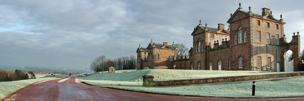 Chatelherault Hunting Lodge, South Lanarkshire
You get some idea of the commanding view seen from Chatelherault in this photo, in the distance the tower blocks of Motherwell can be seen.  Although there is some optical distortion in the photo due to it being about 3 joined together, the apparent tilt in the two end blocks is real and has been caused by subsidence due to old mine workings.  This view also shows that although it was designed to look very grand from the front the buildings have very little depth.
