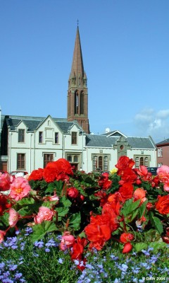 Summer flower on Largs Sea front with Clark Memorial Church in background
