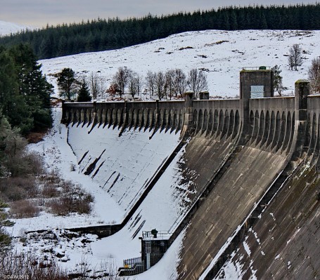 Clatteringshaws Hydro Dam in winter
Built in the 1930's as part of the Galloway Hydro-Electric power scheme the entire system can still generate up to 106MW of clean power.  But at the time of construction it wasn't welcomed by all.  Local poet, W.G.M. Dobie wrote this,

A raider comes today who kills
The glories of our glens and hills
With unheroic acts and bills
and "Private Legislation"
The Company promoters pen
Will Dam the Deugh and dam the Ken
and Dam the Dee - oh Dam the men
Who Plan such desecration!
