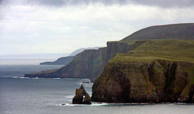 Clo Mor Cliffs, Cape Wrath
Looking east from Cape wrath towards the Clo Mor cliffs.  They are about 4 or  5 miles away so its perhaps not obvious that the Cliffs you see just behind the headland with the sea stacks are the highest cliffs on the British mainland.  At the highest point there is a sheer drop of 281m (920ft) to the sea.  

