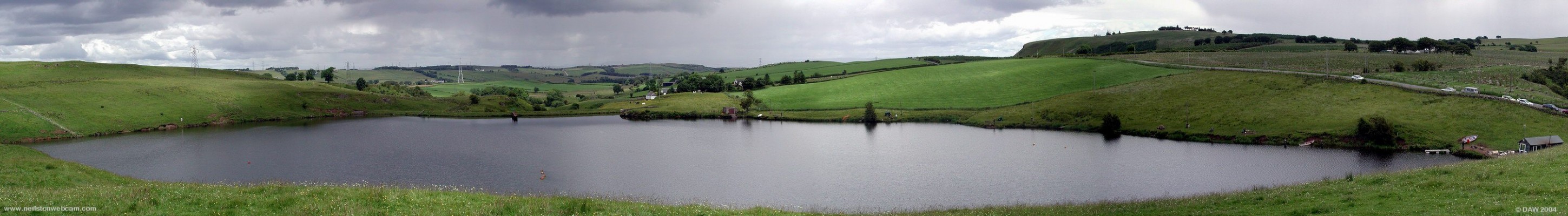 A showery day over looking Commore Dam
Commore Trout Fishery lies a few miles west of Neilston.  As with most of the dams around Neilston and Barrhead it was built to store water for the mills and bleachworks.  In the distance the Lochliboside and Fereneze Hills can be seen, right of centre is the Neilston Pad. 
