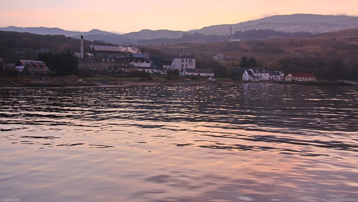Craighouse, Isle of Jura
The main population centre of Jura is here at Craighouse.  The total island population is less than 200.  In this dusk view you can see the Jura Distillery (with the Chimmney), and the Jura Hotel in front.  Craighouse also boasts Jura's only shop.  [url=http://www.streetmap.co.uk/map.srf?X=153055&Y=667002&A=Y&Z=115/] Map location. [/url]
