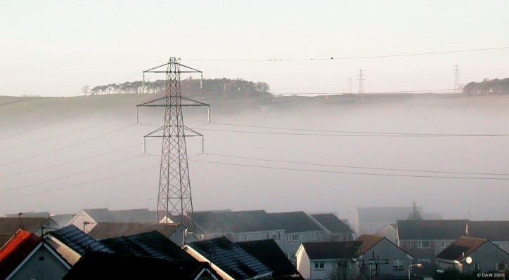 December, AY16 unsuccessfully tries to hide in the mist.
This Pylon at the top end of Neilston was standing all alone in a field long before someone chose to build houses all around it.  The jury is still out as to whether this sort of proximity to housing is a good idea or not. [url=http://www.multimap.com/map/browse.cgi?lat=55.7783&lon=-4.4339&scale=25000&icon=x]Map location.[/url]
