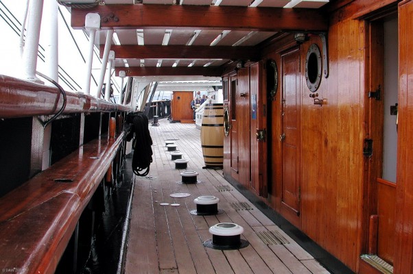 Looking aft along the deck, RSS Discovery, Dundee
To maintain the strength of the wooden hull there are no port holes along the side.  To compensate, the strange objects prodrtuding from the deck are in fact vertical port holes bringing light down into the roofs of the cabins directly below.
