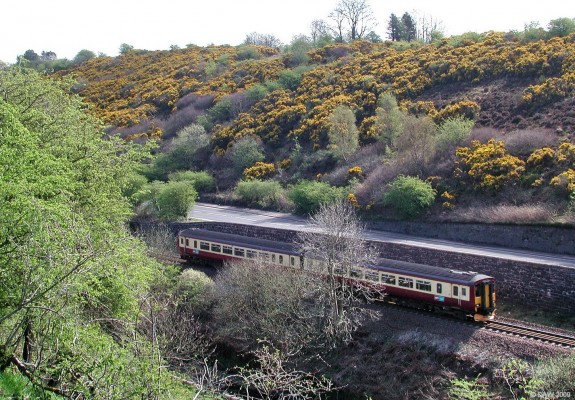 Diesel Sprinter approaching Barrhead from Kilmarnock
The Barrhead/ Kilmarnock line was opened in 1870 and up until the 1970's had two lines.  Due to short sighted cost cutting this was reduced to one line in the 1970's resulting in a much poorer service for places like Stewarton and Dunlop.  The error of this has long been realised and today a 'dynamic loop' is being constructed between Lugton and Stewarton which means train numbers can be increased and can pass on this 5 mile stretch without stopping.
