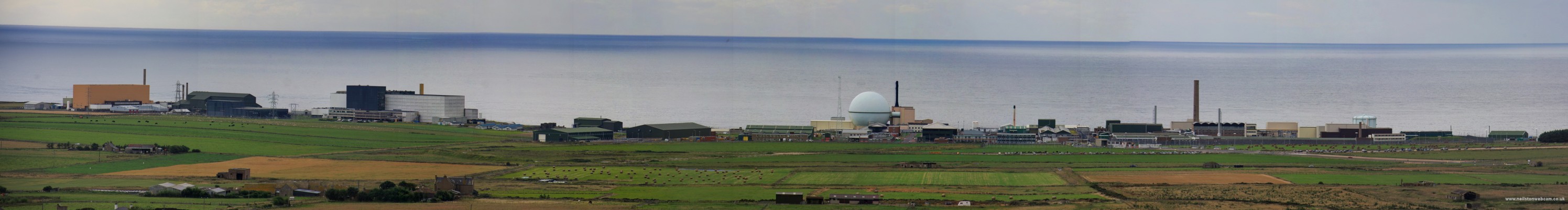 Dounraey Nuclear Site
Panoramic view of the Dounraey Nuclear test site.  The orange coloured building on the left is the Shore Test facility (STF) of the Vulcan Reactor Test Establishment of the Roytal Navy.  The large white building to the right is the Prototype Fast Reactor and the classic Dome in the centre is the Dounraey Fast Reactor.  The two fast reactors are now decomissioned but the STF is still in use and has the Royal Navy Core H Submarine Reactor under test.
