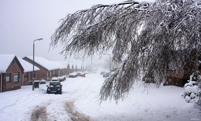 Duncarnock Crescent, February 2010
Taken on the day of the heaviest snow in Neilston for 10 years.  You'll see another very similar photo taken from nearly the same spot in 2000 with much the same depth of snow but the difference being they did a much better job of ploughing it that time!
