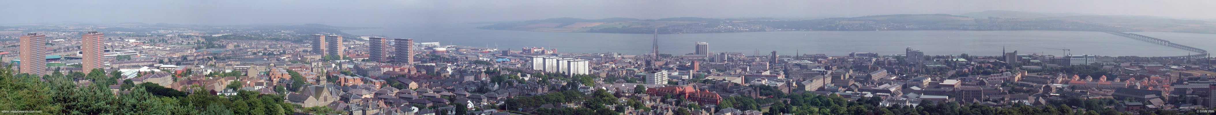 Dundee Law panoramic view
An overview of the City of Dundee from the view point at the top of Dundee Law.  Between the two tower blocks on the left is Dens Park football ground and to the right of that is Tanadice Park, the grounds of Dundee Football Club and Dundee United respectively.  The Castle at Broughty Ferry is visible in the haze above the 4 tower blocks, to the right of the road bridge you can spot the masts of RRS Discovery and on the extreme right is the rail bridge, made infamous by the collapse of its predecessor.
