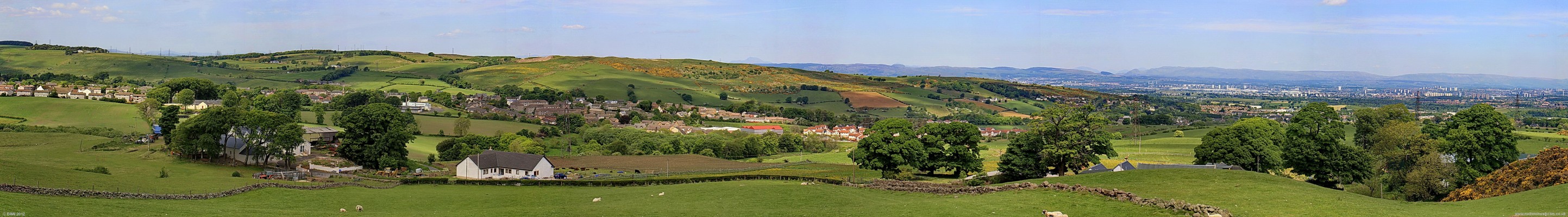 Dyke Hill Panorama, 2010
Overlooking Neilston from Dyke Hill.  What was Loanfoot farm is in the foreground on the left and Dyke farm is behind the group of trees on the right.  Yellow broom cover the top of the Fereneze Braes in the centre and Greater Glasgow can be seen in the distance on the right. [url=http://www.streetmap.co.uk/map.srf?X=248817&Y=656215&A=Y&Z=115/] Map location. [/url]
