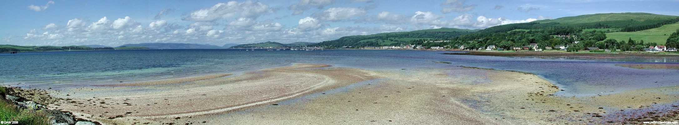 Panoramic view from Fairlie
Taken from the embankment at the Ore terminal just south of Fairlie.  Fairlie streches along the coast on the right, furth up in the distance is Largs with Knock hill behind it.  On the left is the Great Cumbrae.  Before the Ore Terminal was built in the early 70's this area was all sand flats and when the tide was out it appeared like you could almost walk to the Cumbrae.  [url=http://www.streetmap.co.uk/streetmap.dll?G2M?X=220470&Y=654310&A=Y&Z=3/]Map location.[/url]
