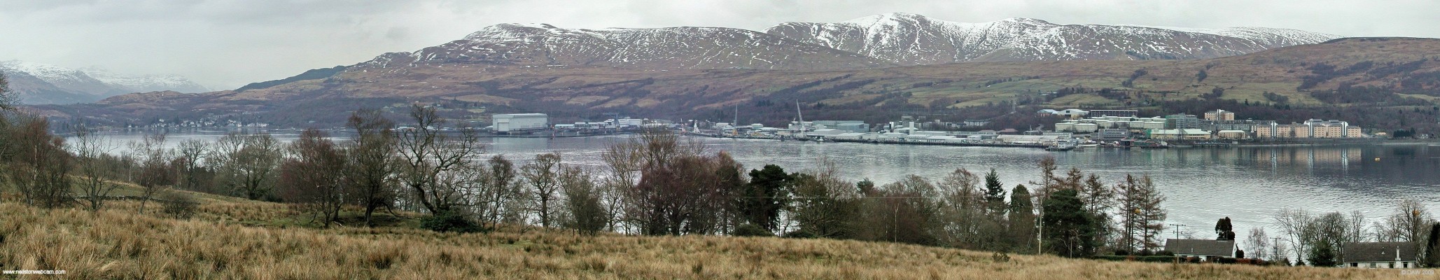 Over looking Gare Loch towards Faslane Naval Base, 2006
In 2006 Faslane became the home for Mine Counter Measure Squadron 1 which consists of all 8 of the Sandown class ships.  They are normally berthed on the right hand side but on this day all appear to be deployed somewhere.  New accomodation blocks for sailors are being completed on the right.   The small community of Garelochhead can be seen at the extreme left at the top of the loch [url=http://www.streetmap.co.uk/map.srf?X=223255&Y=687327&A=Y&Z=120&ax=223120&ay=687207/] Map location. [/url]
