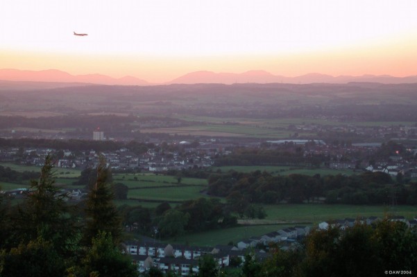 Final approach
Aircraft on final approach to runway 05 at Glasgow Airport.  Taken at dusk from the Gleniffer Braes looking north over the west end of Paisley.
