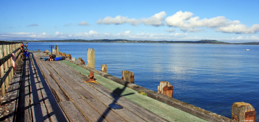 Island of Gigha from Tayinloan Pier
Looking over to the Island of Gigha off the west coast of Kintyre on a perfect August summers Day.  [url=http://www.streetmap.co.uk/map.srf?X=169177&Y=646686&A=Y&Z=115&ax=169265&ay=646564/] Map location. [/url]
