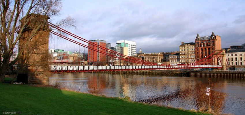 South Portland Street Suspension Bridge
Early morning winter sun illuminates the buildings on the north side of the river Clyde in the City centre.  The bride was opened in 1853 but has undergone considerable refurbishments over the years, the stone pillars are the only part that now actually date from 1853.  [url=http://www.streetmap.co.uk/map.srf?X=258928&Y=664646&A=Y&Z=106/] Map location. [/url]
