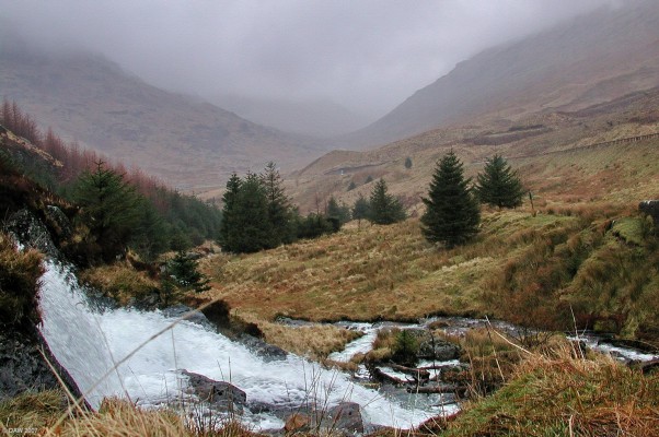 Looking towards Glen Kinglass
After a day of heavy rain the burn that drains Loch Restil is a torrant of water as it heads down into Glen Kinglass.  The main A83 North can be seen up on the right.  [url=http://www.streetmap.co.uk/streetmap.dll?G2M?X=223530&Y=709180&A=Y&Z=3/]Map location[/url]
