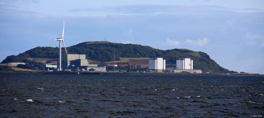 Hunterston from Largs, 2014
Looking over towards the Hunterston Peninsula.  The white buildings on the right are the now decommissioned Hunterston A power station, they grey buildings are Hunterston B which probably only has a few more years to go before it closes.  The wind turbine on the left sits in the former oil rig construction yard and is presently a test site for off shore turbines. There are 2 turbines, the highest of which is 193m tall.
