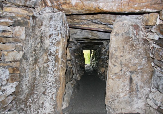 Inside the round Cairn, Camster
Looking out along the entrance passageway from inside the round chambered Cairn at Camster.  You have to crawl along the passage but once inside it is possible to stand up.  Parts of two skeletons were found in the passage when it was excavated in 1865. The Cairn is thought to have been constructed some 5,000 years ago. [url=http://streetmap.co.uk/map.srf?X=326087&Y=944040&A=Y&Z=115/] Map location. [/url]
