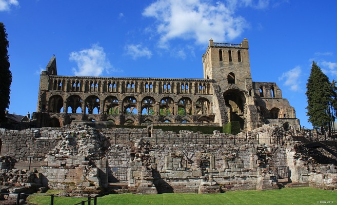 Jedburgh Abbey from the South
The ruins of the 12th century [url=http://www.historic-scotland.gov.uk/propertyresults/propertyabout.htm?PropID=PL_163&PropName=Jedburgh%20Abbey/] Jedburgh Abbey. [/url]  It took 120 years to build this church, during that time architectural styles changed.  The Gothic arches on the Nave on the left hand side show that this was built at a later time than the rest of the building. 
