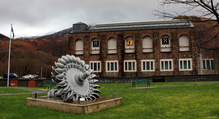 Part of the former Aluminium smelter at Kinlochleven
This is about all that remains of the large Aluminium Smelter that was built here between 1905 and 1909.  It had its own Hydro Electric power station, the largest of its type at the time.  One of the turbines can be seen here.  This building is found a new use as an [url=https://www.ice-factor.co.uk/] Ice climbing centre. [/url]
