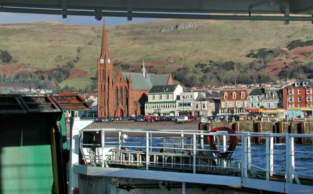 Largs from the Cumbrae Ferry
The view the intrepid traveller sees on returning from an overseas trip to the Great Cumbrae, an epic crossing of some 15 minutes, apparently the most expensive car ferry in Scotland.  The winter sun highlights the red sandstone of St Columba's Church, the old stone pier is on the right.  [url=http://www.streetmap.co.uk/streetmap.dll?G2M?X=219925&Y=659540&A=Y&Z=3/] Map location[/url]
