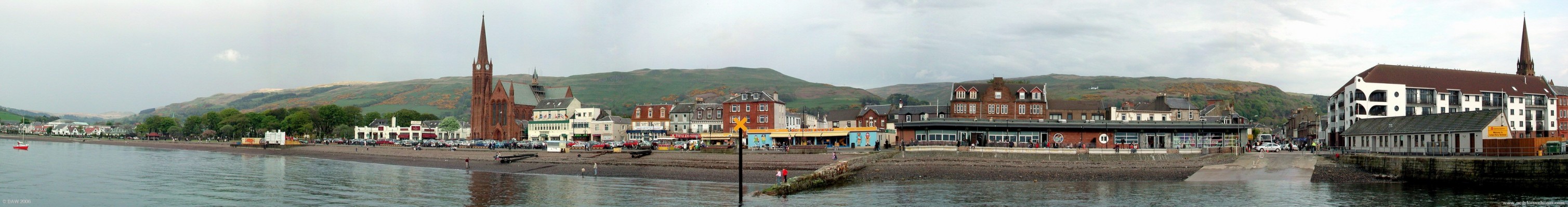 Spring panoramic view of harbour and seafront, Largs
The two spires are from the Clarke Memorial on the right and St. Columba's on the left.  The flats on the right hand side are where "The Moorings" used to stand.  Like Nardini's, it was owned by an Italian family.  Being such a landmark, when it was demolished it was decided to replace it with a building of similar style, hence the prominant bow shaped corner.  Nardini's can be seen to the left of St Columba's Church.
