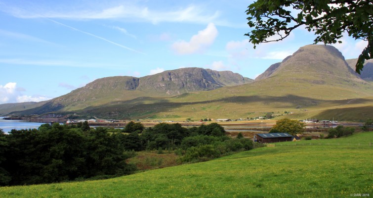 Loch Kishorn
Looking across Loch Kishorn, on the right Sgurr a Chaorachain rises to some 792m.  On the left at the shore you can see what appears to be cliffs.  This is a dry dock constructed in the 1970's and used to construct the concrete base for the Ninian Oil field.  It was only used once more to fabricate parts for the Skye Bridge.  After more than 20 years it is about to have a new lease of life as the fabrication base for a new off shore wind farm.

