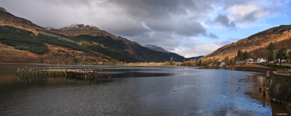 Loch Long and Arrochar
A view of the top of Loch Long with the remains of Arrochar Pier.  The Pier was built in 1850 for the many passenger steamers that used to ply the Clyde at that time.  The high point for the Clyde Steamers was probably the 1930's,  As road transport took over the pier fell into disuse and was abandoned. [url=http://streetmap.co.uk/map.srf?X=229570&Y=703965&A=Y&Z=120/] Map location. [/url]
