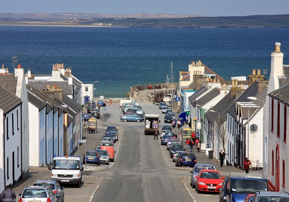 Looking down Bowmore Main Street, Islay
The view down to the harbour from the Round Church at the top of the Main Street in Bowmore.  Bowmore was founded in 1768 and was constructed as a planned town.  The streets are laid out on a grid pattern with the main street as the axis.  [url=http://www.streetmap.co.uk/map.srf?X=131149&Y=659639&A=Y&Z=115/] Map location. [/url]
