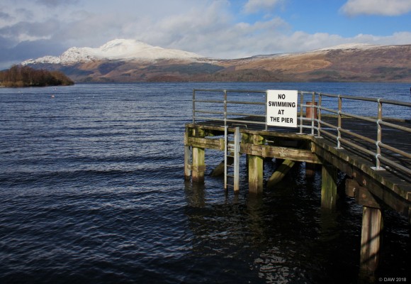 Luss Pier, Loch Lomond
The view from Luss Pier in winter, a snow covered Ben Lomond is in the distance.  I doubt if that sign is really necessary in winter. [url=http://streetmap.co.uk/map.srf?X=236120&Y=693065&A=Y&Z=120/] Map location. [/url]
