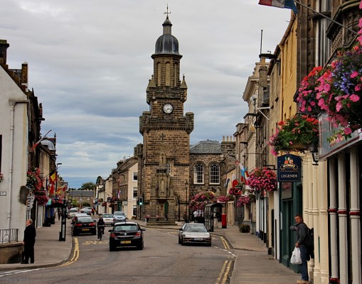 Main Street, Forres
Forres is one of Scotland's oldest towns, having been a Royal Burgh since 1140.  It once had a castle but no traces of it remain.  Today it is by-passed by the main trunk road to Inverness but is well worth making the detour for a visit.  The tower here is the Tollbooth with the Mercat Cross in front.
