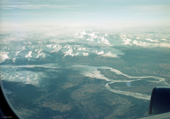 Mount Mckinley, Alaska 1985
I was assured that one of the peaks you see in the top centre of this photo is Mount McKinley.  At around 20,000ft it is the highest peak in North America.  Since 1985 the mountains name has reverted back to Denali, the name given by the iKoyukon people who have always lived in the area.  The reasuring outline of the inboard engine of a Boeing 747 is in the foreground.

