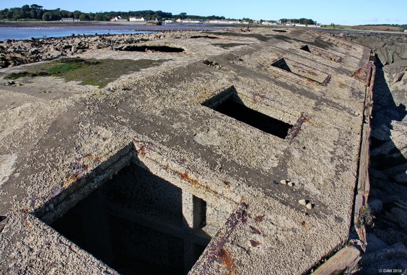 Mulberry Harbour Beetle, Garlieston Bay
One of the Mulberry 'Beetles' at Garlieston Bay.  The harbour and village of Garlieston is in the background.  Garlieston and nearby Rigg Bay was used for testing many parts of the D-Day harbour.  The Beetles were used to support the roadway out the pier head.  The large holes were for posts that would keep the Beetle in place but allow it to float with the tide. [url=http://streetmap.co.uk/map.srf?X=248589&Y=546694&A=Y&Z=115/] Map location. [/url]
