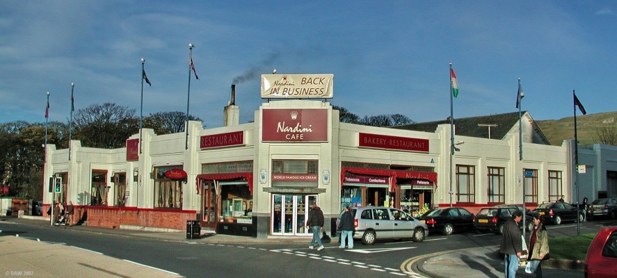 Nardini, Largs
The name Nardini's and Largs are inseperable.  This art deco building has been the source  of quality icecream for day trippers since the 1930's.   A day in Largs was  incomplete without a visit to Nardini's.  Sadly the business got into problems in the last few years and this photo was taken in 2004 shortly before it "temporarily" closed for refurbishment.  At the time of writing in 2007 there is still no sign of work being carried out on the restoration of the building.
