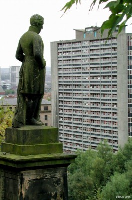 A Stautue in the Necropolis keeps a watchfull eye over a Glasgow tower block
