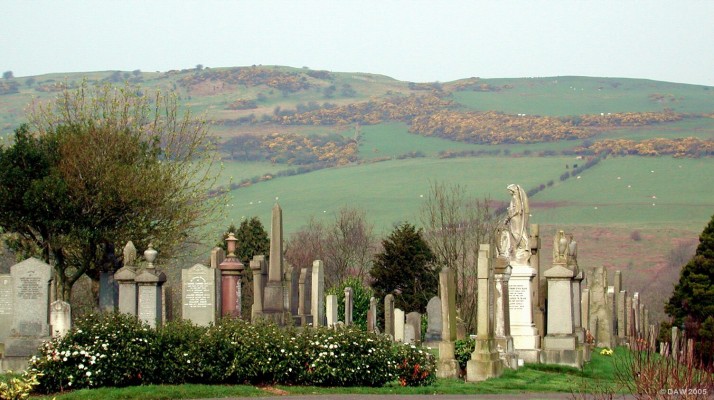 Neilston Cemetery
As the population of Neilston expanded the cemetery around the Parish Church became too small, a temporary measure was to use the Cemetery of a Church in Barrhead.  Around 1878 the Neilston Cemetery was constructed, just outside Barrhead.  This view is of the older part of the cemetery looking towards the Ferenze hills.  In 2004/05 the cemetery was once again expanded into an adjacent field.
