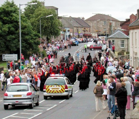 2005, The Pipe Bands head up the main street
Crowds line the street to watch the combination of the Tokyo Pipe Band, The Royal Pipe Band of the deputation of Ourense and the Neilston & district Pipe Band.  Unfortunately those further up the main street got a surprise when they made a sharp left turn up into High Street.
